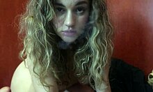 Cute blonde girl with big boobs gives you a blowjob while smoking a cigarette